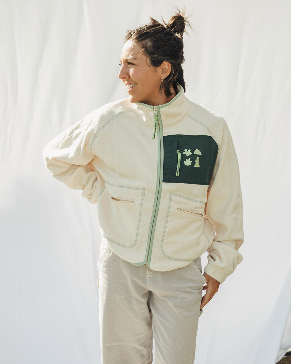 Person wearing a beige jacket  with green accent women