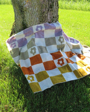Checkered blanket laying on a tree