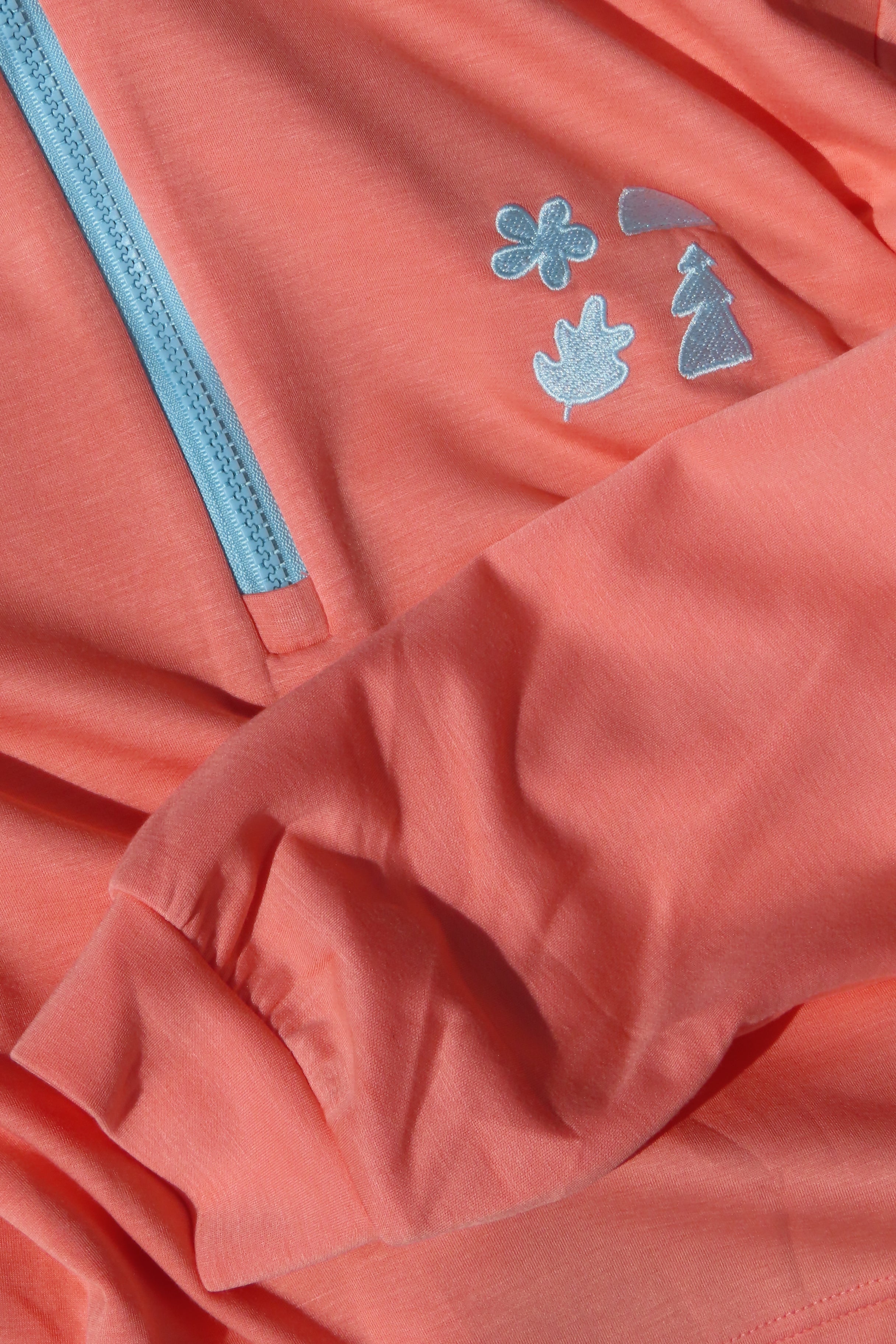 Close-up of a pink jacket with blue Les Saisons design