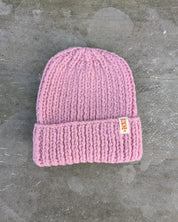 Pink knit beanie with a brand tag les Saisons - Merino Wool 