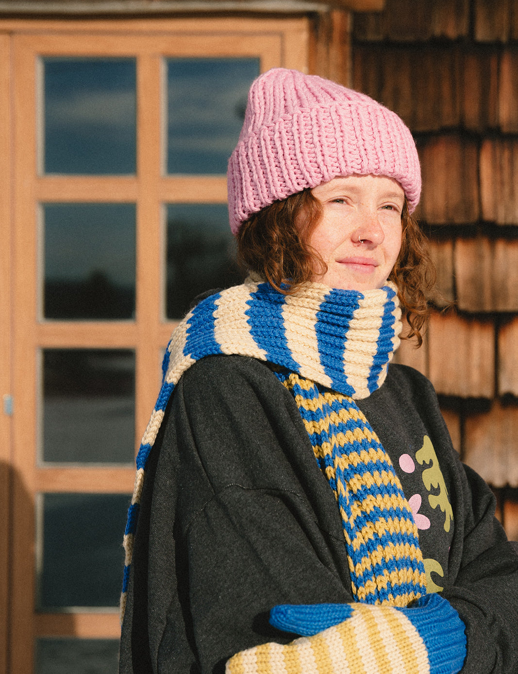 Girl wearing a merino scarf from nepal_blue beige and greenish yellow_Les Saisons