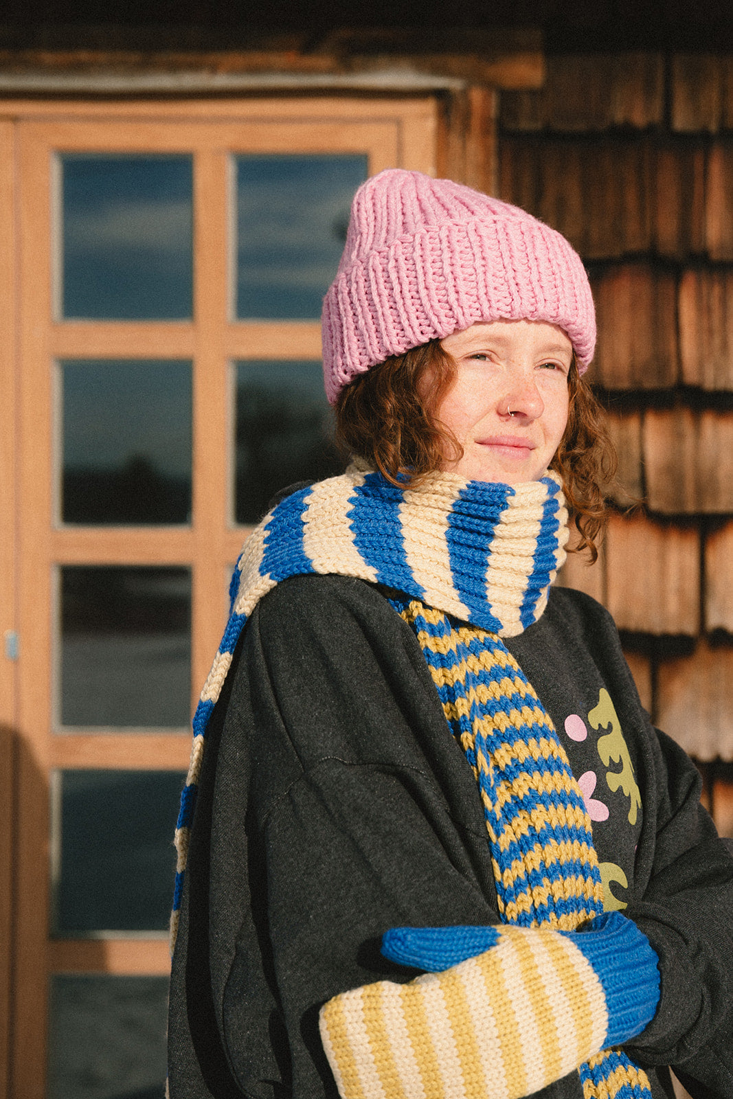 Girl wearing a merino scarf from nepal_blue beige and greenish yellow_Les Saisons