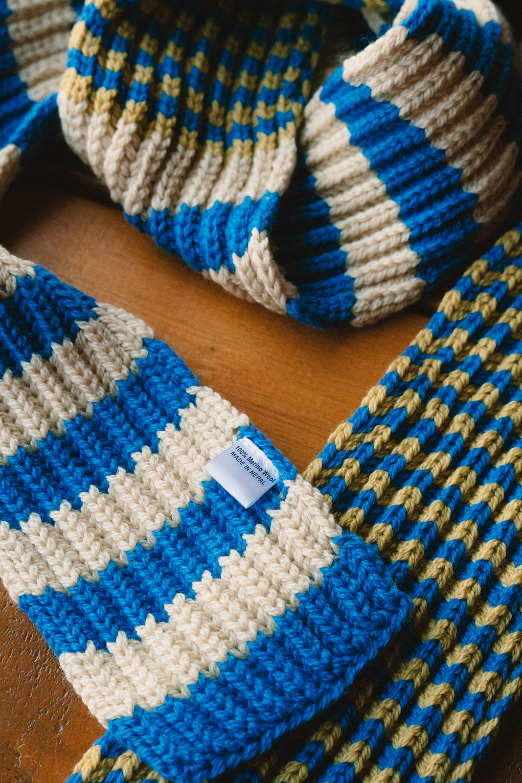 zoomed in picture of details of a merino scarf_blue beige and greenish yellow_nepal_winter