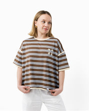 Woman wearing a brown and butter striped t-shirt with small les Saisons icons logo 