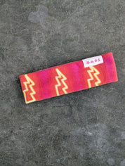 Lightning patterned orange and pink fleece bandana
