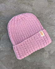Pink knit beanie with a brand label les Saisons Merino wool